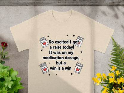 Cream t-shirt with "So excited I got a raise today!" and medication graphics.