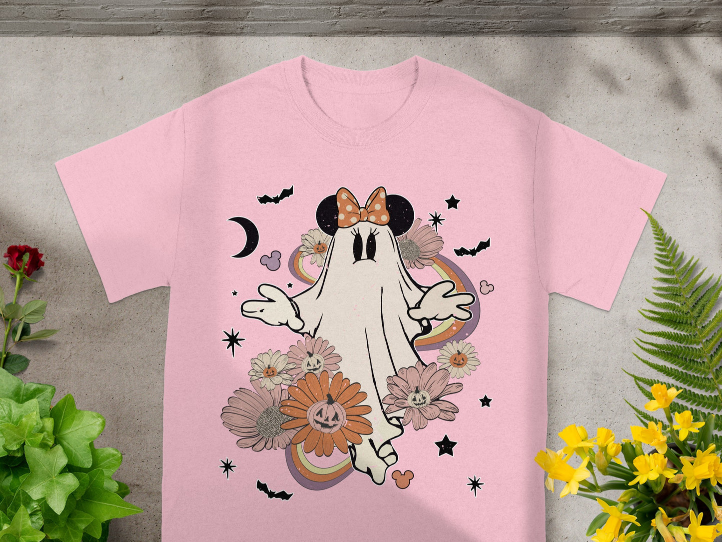 Pink t-shirt with a ghost graphic, pumpkins, flowers, bats, and rainbow.