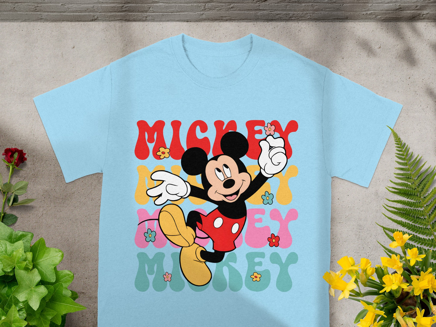 Light blue t-shirt with Mickey Mouse and colorful "Mickey" text.