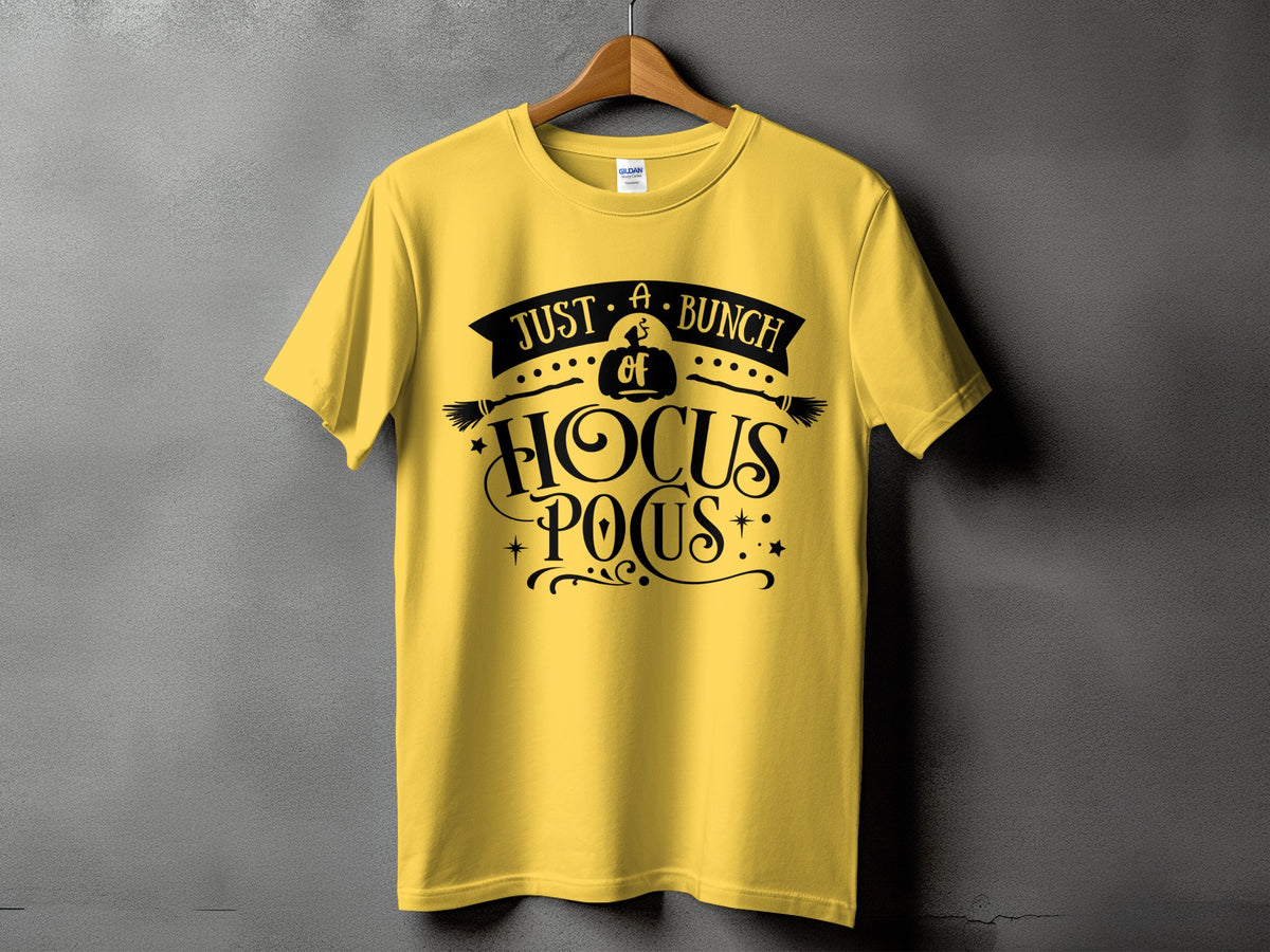 Yellow t-shirt with black "Just A Bunch of Hocus Pocus" graphic and broomsticks.