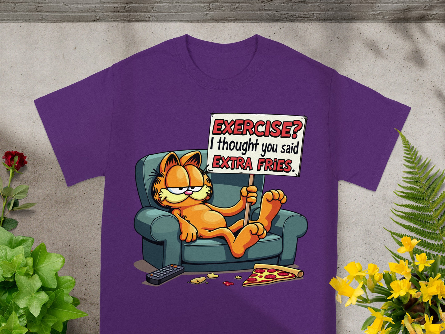 Garfield sitting on couch holding sign "Exercise? I thought you said extra fries".