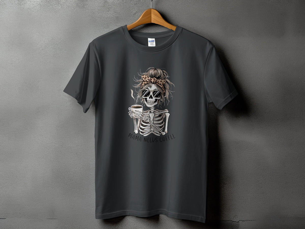 Dark grey t-shirt with skeleton holding coffee, text "MAMA NEEDS COFFEE".