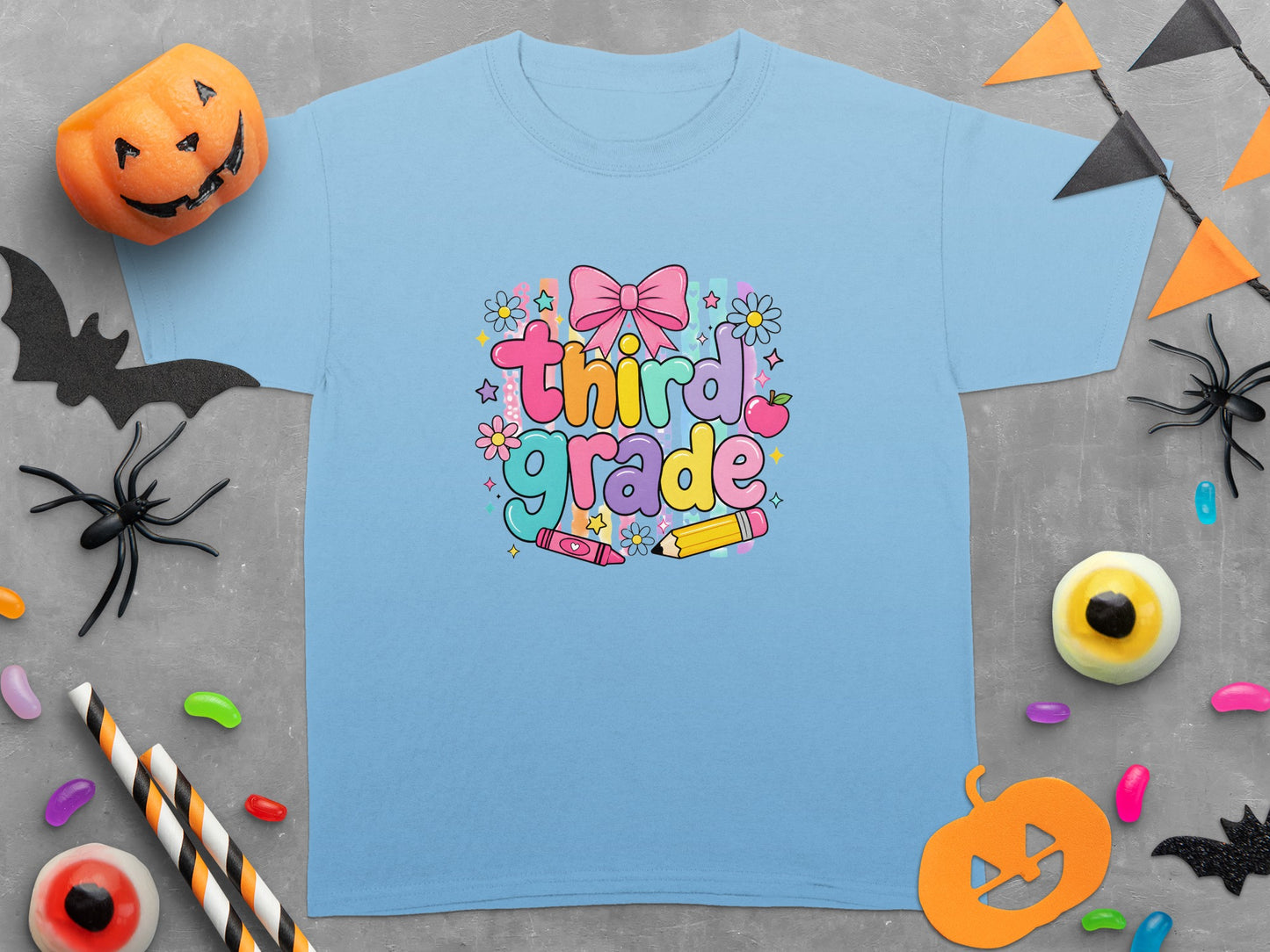 Light blue t-shirt with "Third Grade" text, pink bow, flowers, and school supplies.