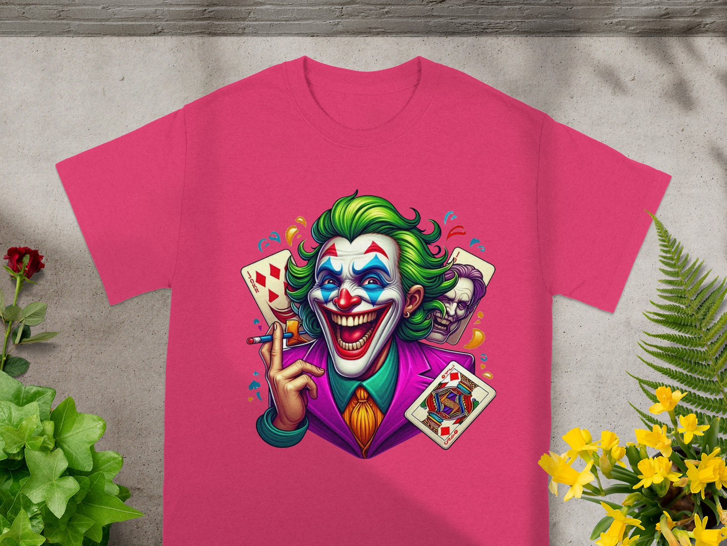 Joker character graphic on a pink t-shirt with playing cards.