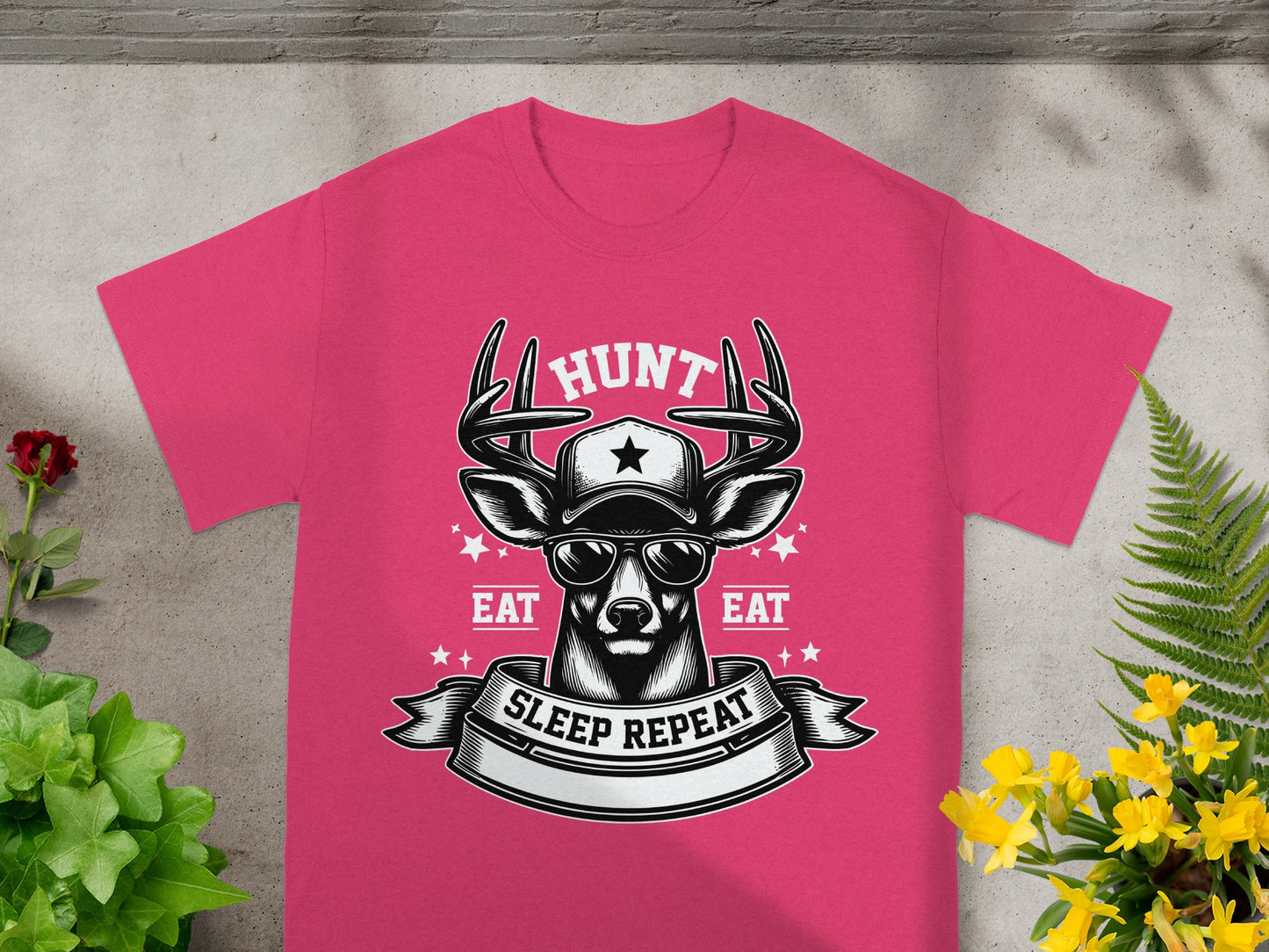 Deer graphic with sunglasses and text "Hunt, Eat, Sleep Repeat" on pink t-shirt.