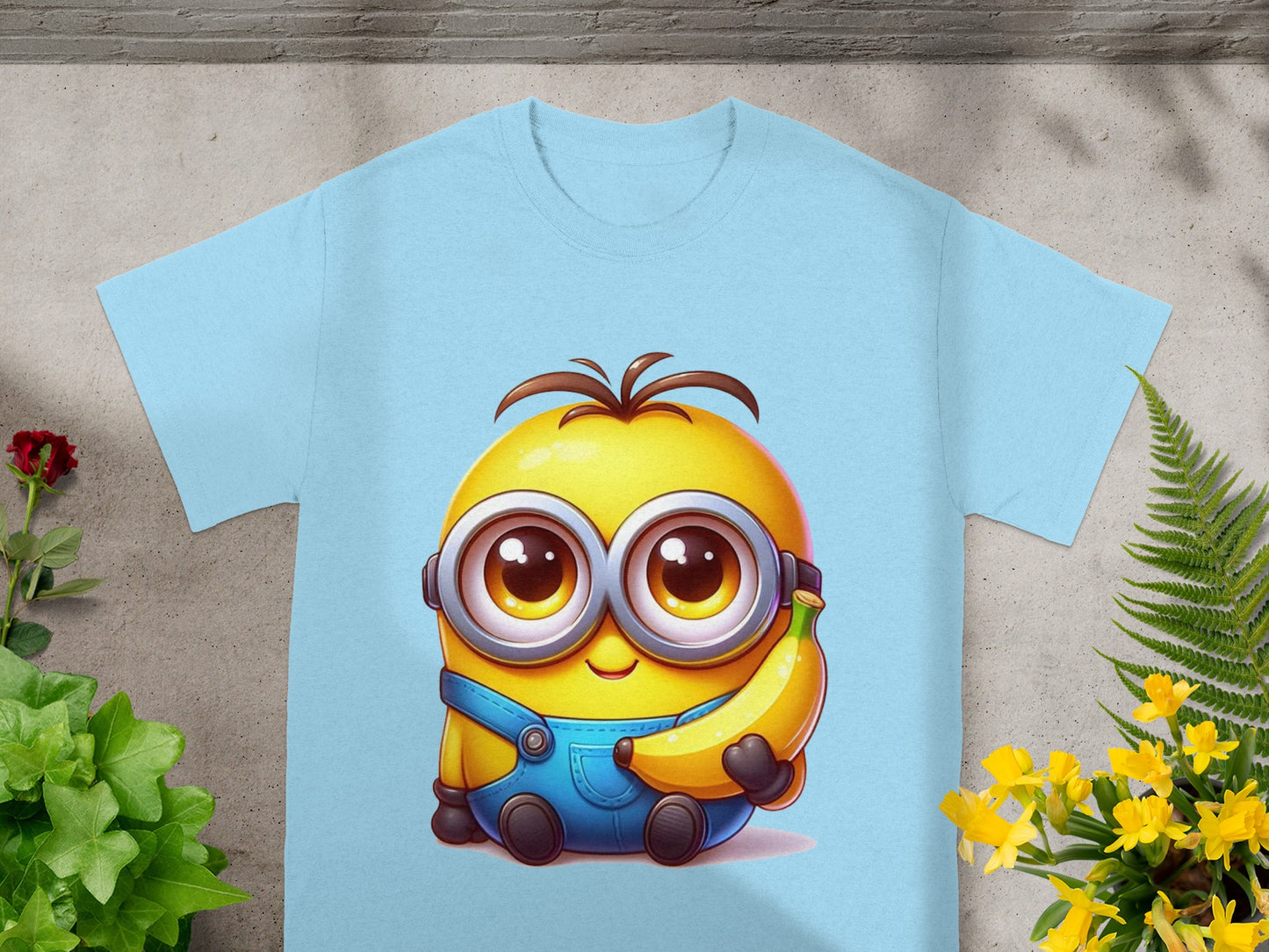 Light blue t-shirt featuring a cartoon minion holding a banana.