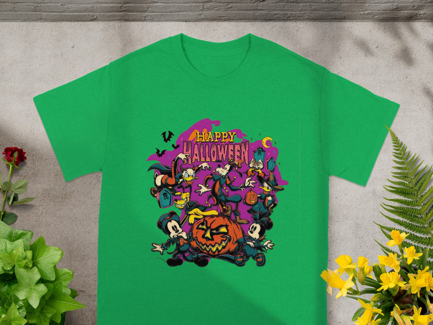 Green t-shirt with cartoon characters and happy Halloween text.