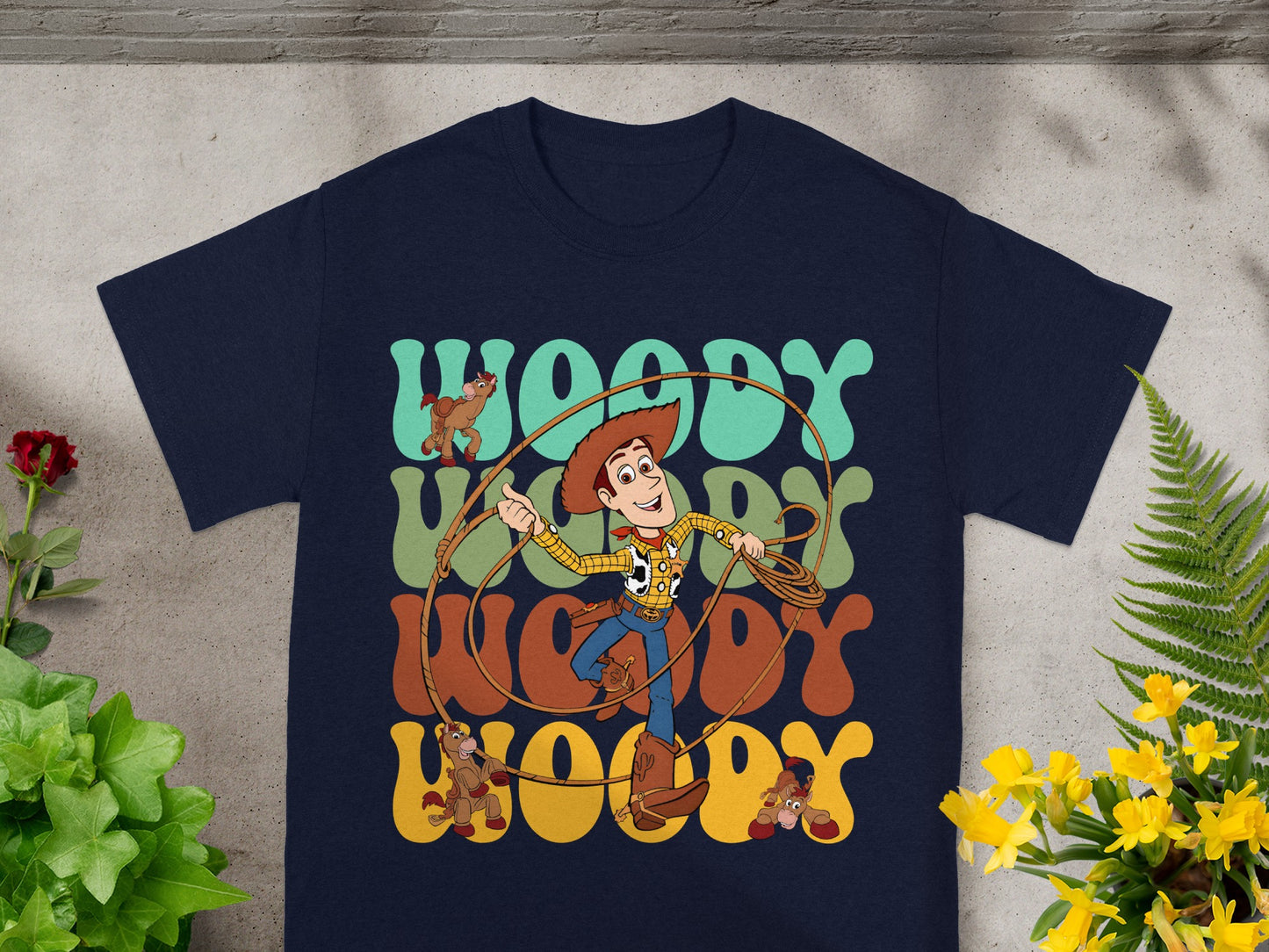 Woody from Toy Story with horses and "WOODY" text on a navy t-shirt.