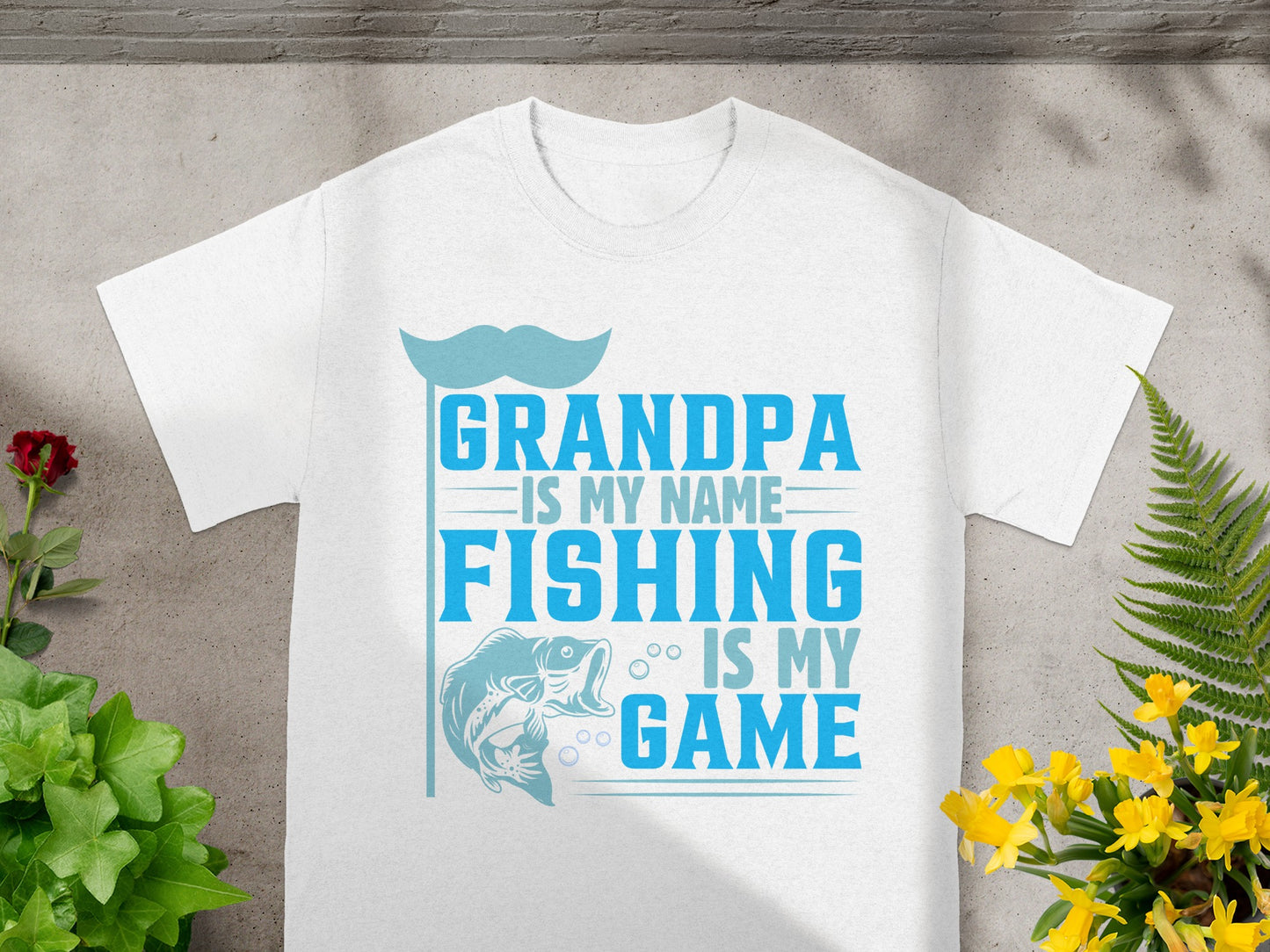 White t-shirt with text "Grandpa is my name, fishing is my game" and fish graphic.