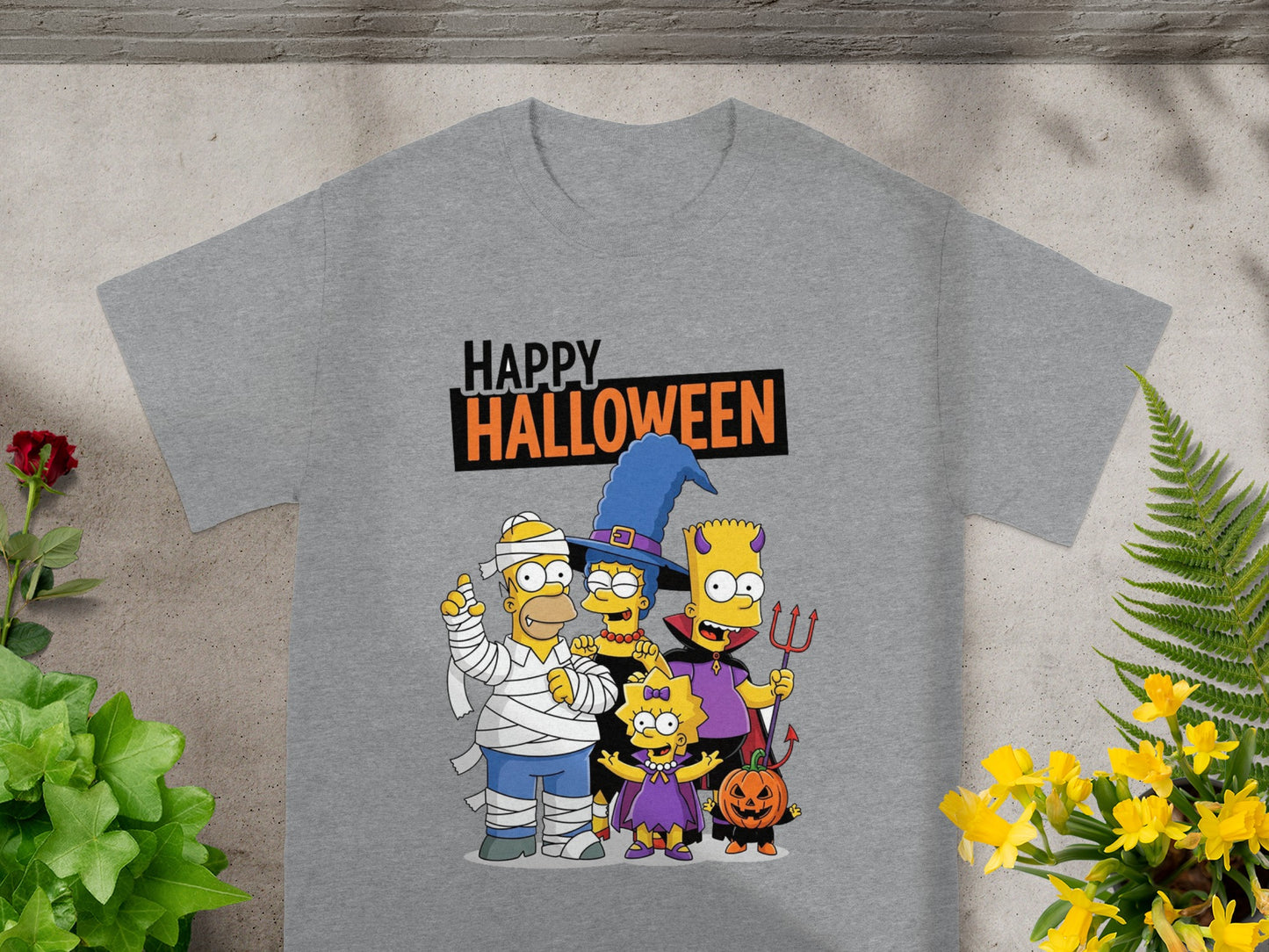 Simpsons family in Halloween costumes with "Happy Halloween" text on a grey t-shirt.