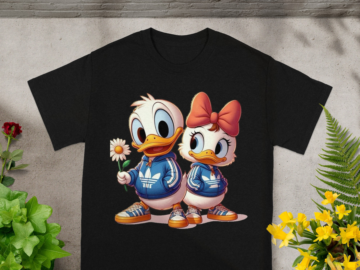 Two cartoon ducks, Daisy and Donald, wear matching tracksuits with a flower.