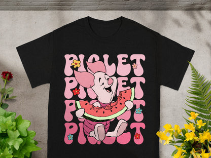 Black t-shirt with Piglet character eating watermelon and floral accents.
