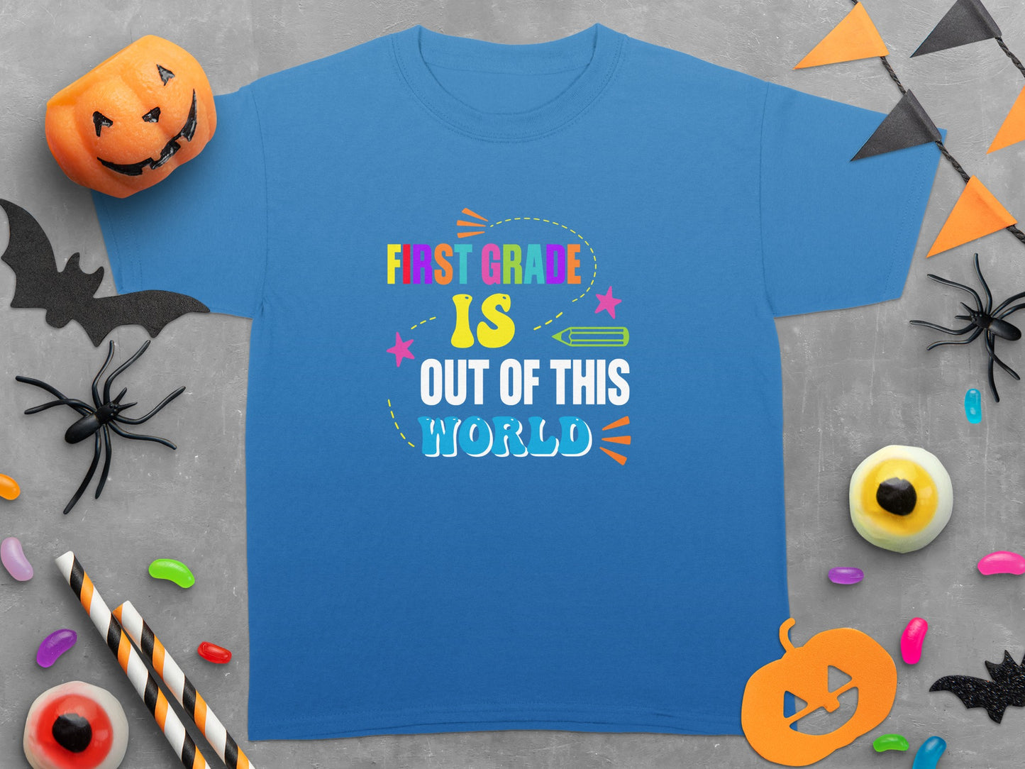 Blue t-shirt with "First Grade is Out of This World" text and Halloween decorations.