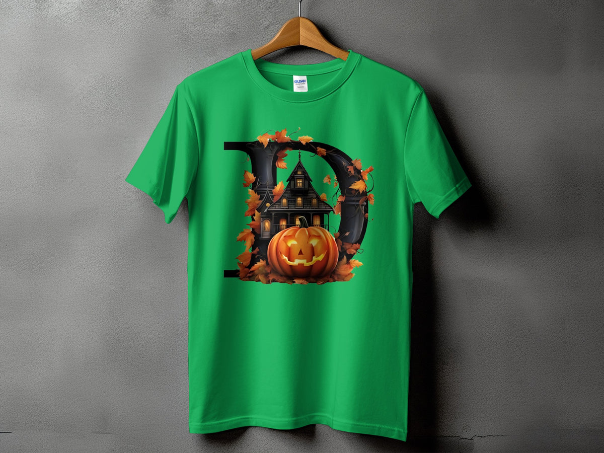 Green t-shirt with a graphic of a black letter D with a spooky house and pumpkin.