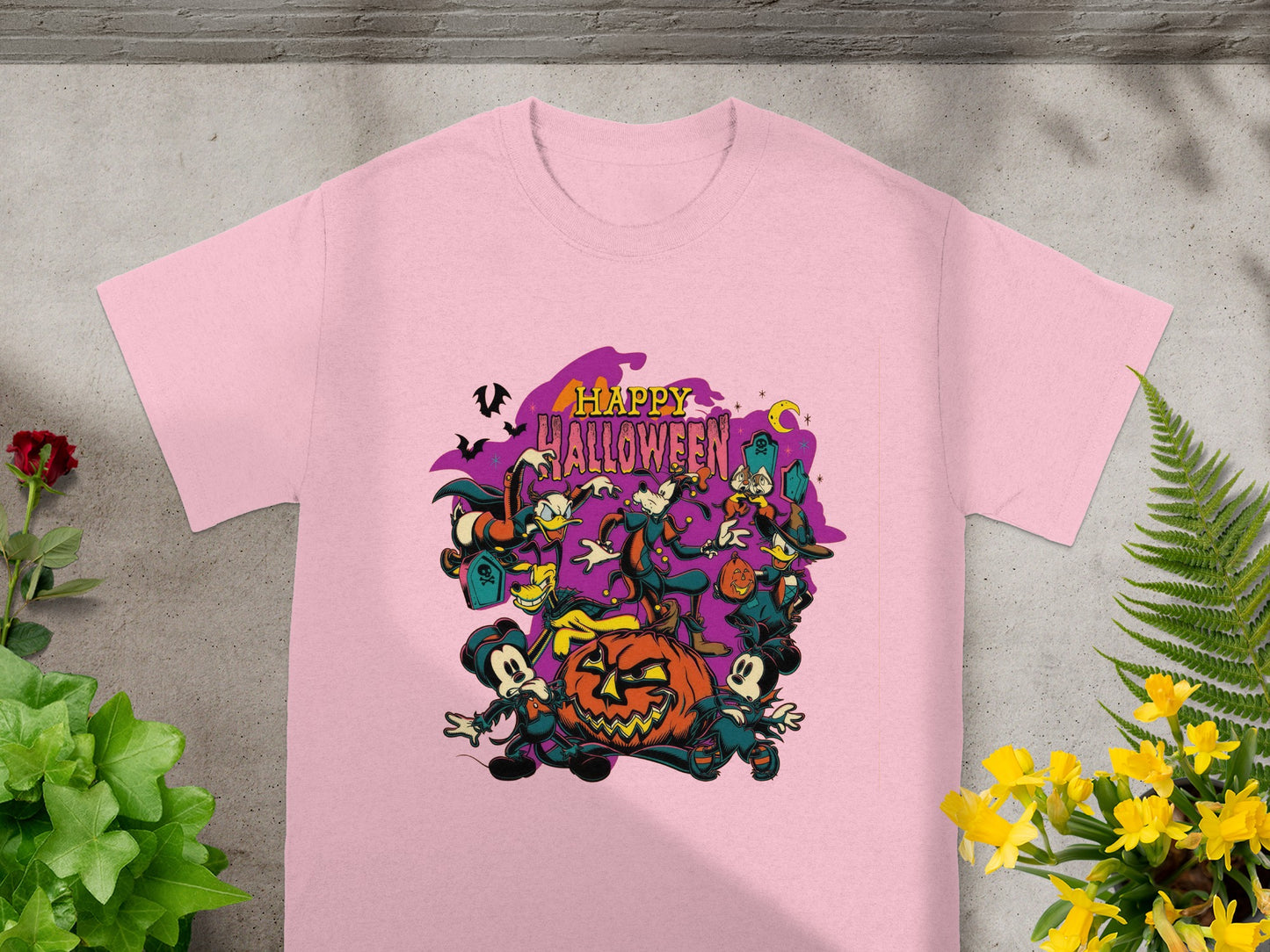 Pink t-shirt with Disney characters celebrating Happy Halloween around a jack-o'-lantern.