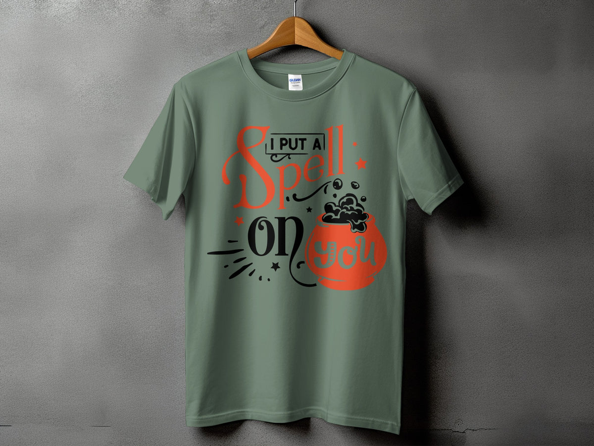 Green t-shirt with "I PUT A Spell ON YOU" and cauldron graphic.