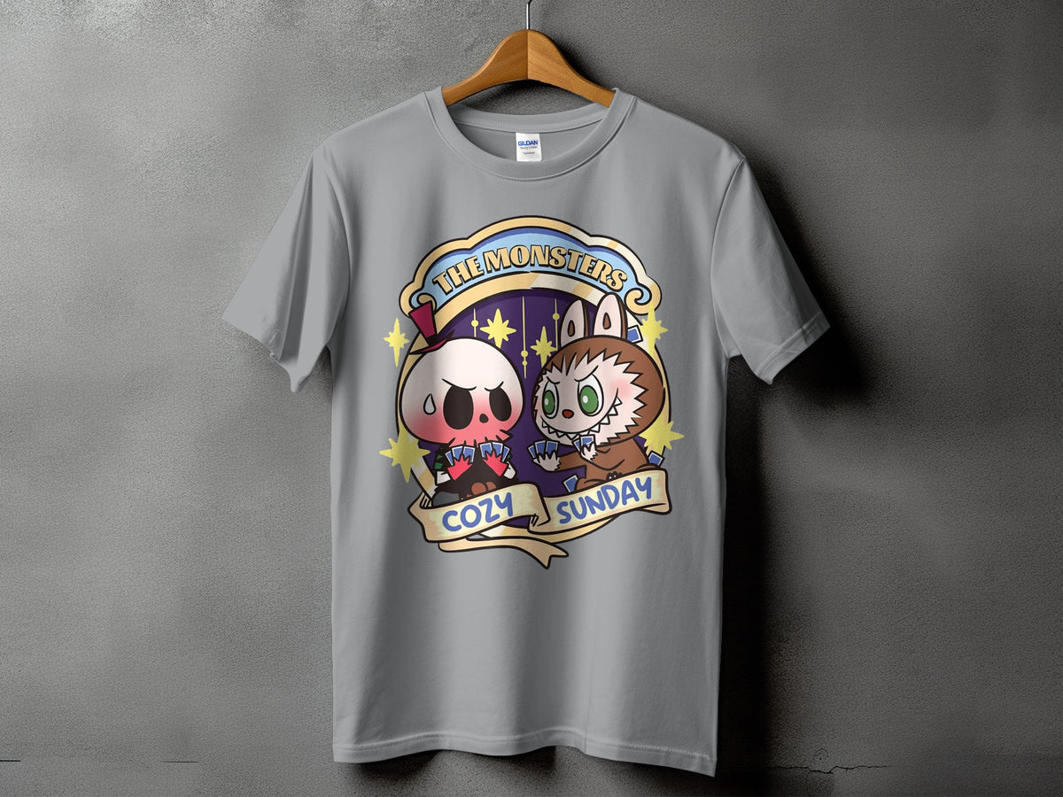 Gray t-shirt with cartoon skull and werewolf characters playing cards, text "The Monsters Cozy Sunday".