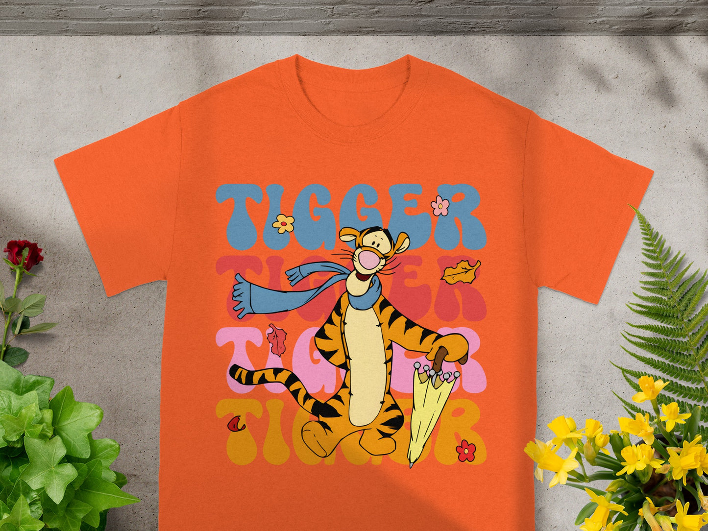 Tigger graphic t-shirt with "Tigger" text and falling leaves.