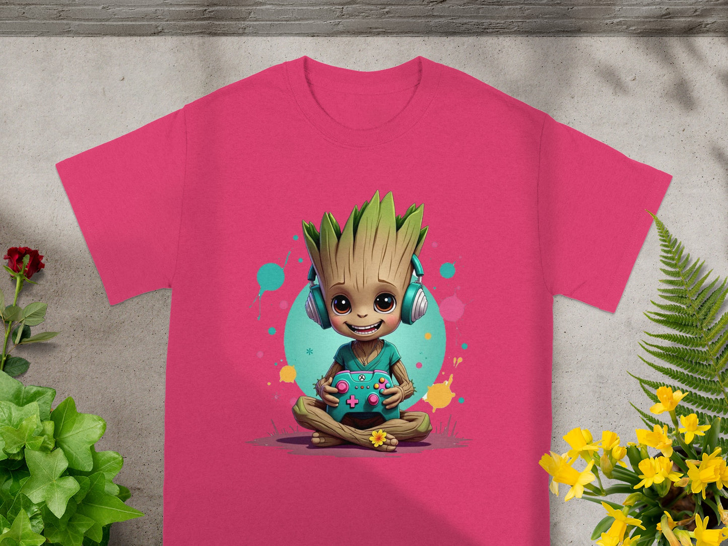 Pink t-shirt with a cartoon Groot character playing a video game.