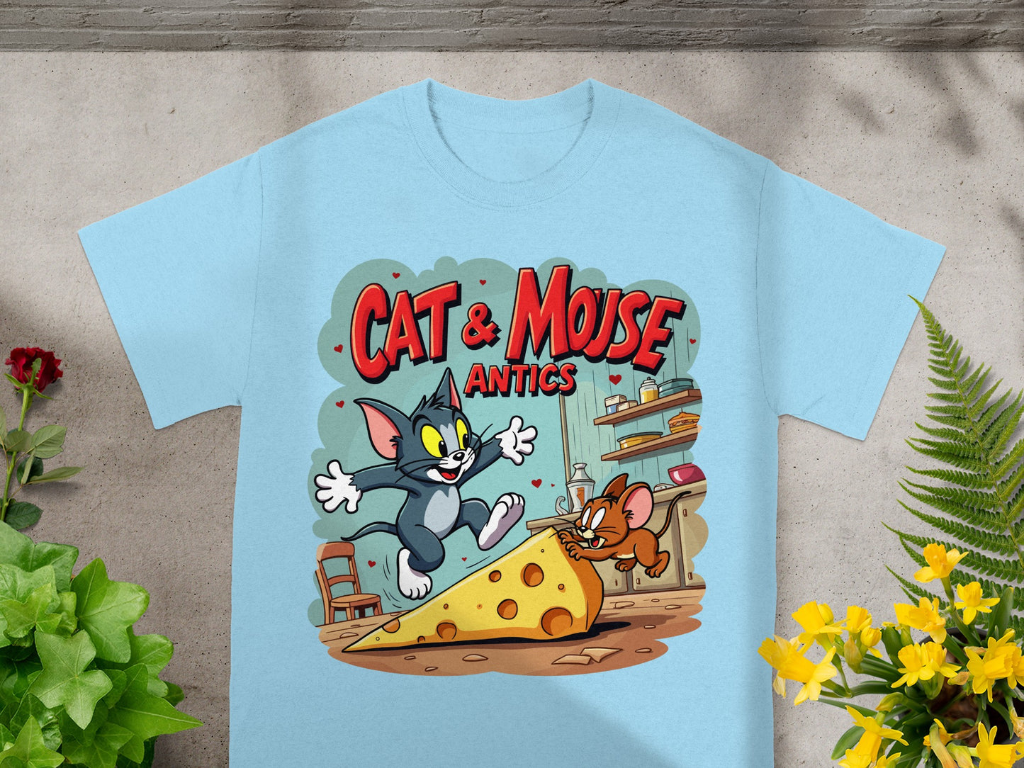 Light blue t-shirt with Cat & Mouse antics graphic featuring Tom chasing Jerry across cheese.