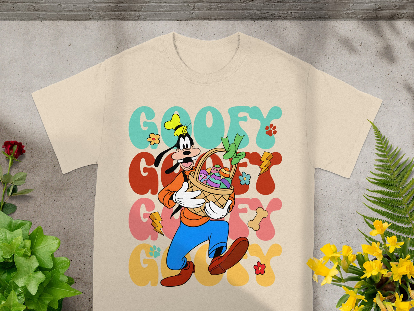 Goofy in a basket with Easter eggs and flowers, "Goofy" text.