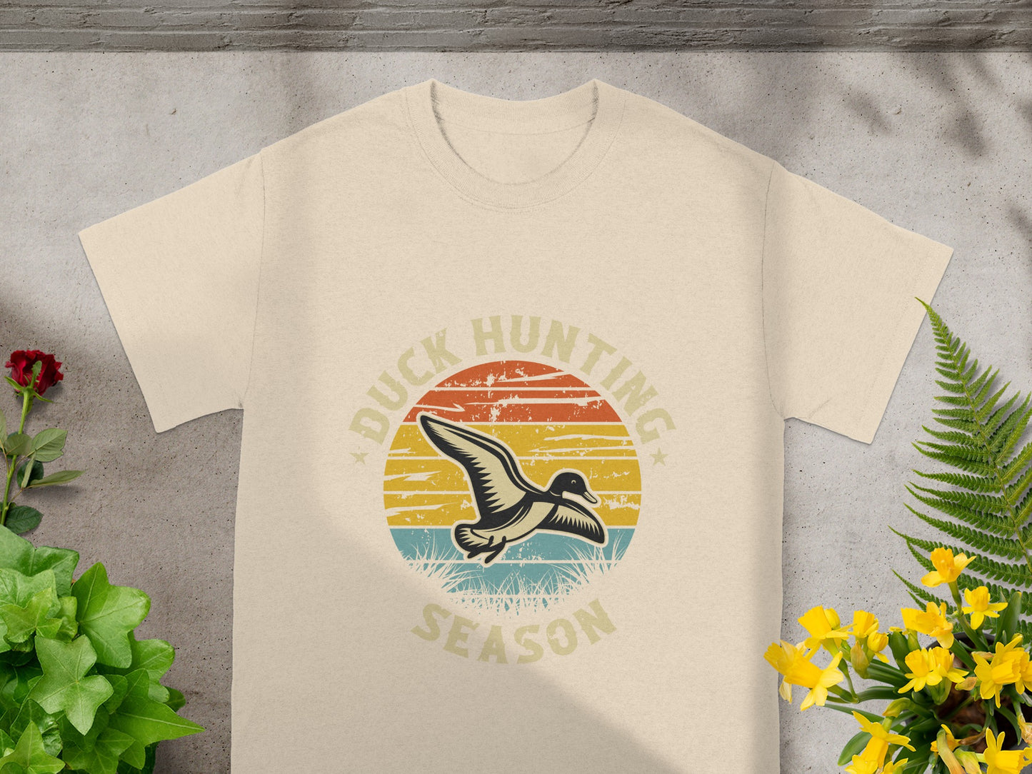 Cream t-shirt with a graphic featuring a duck in flight and "DUCK HUNTING SEASON" text.