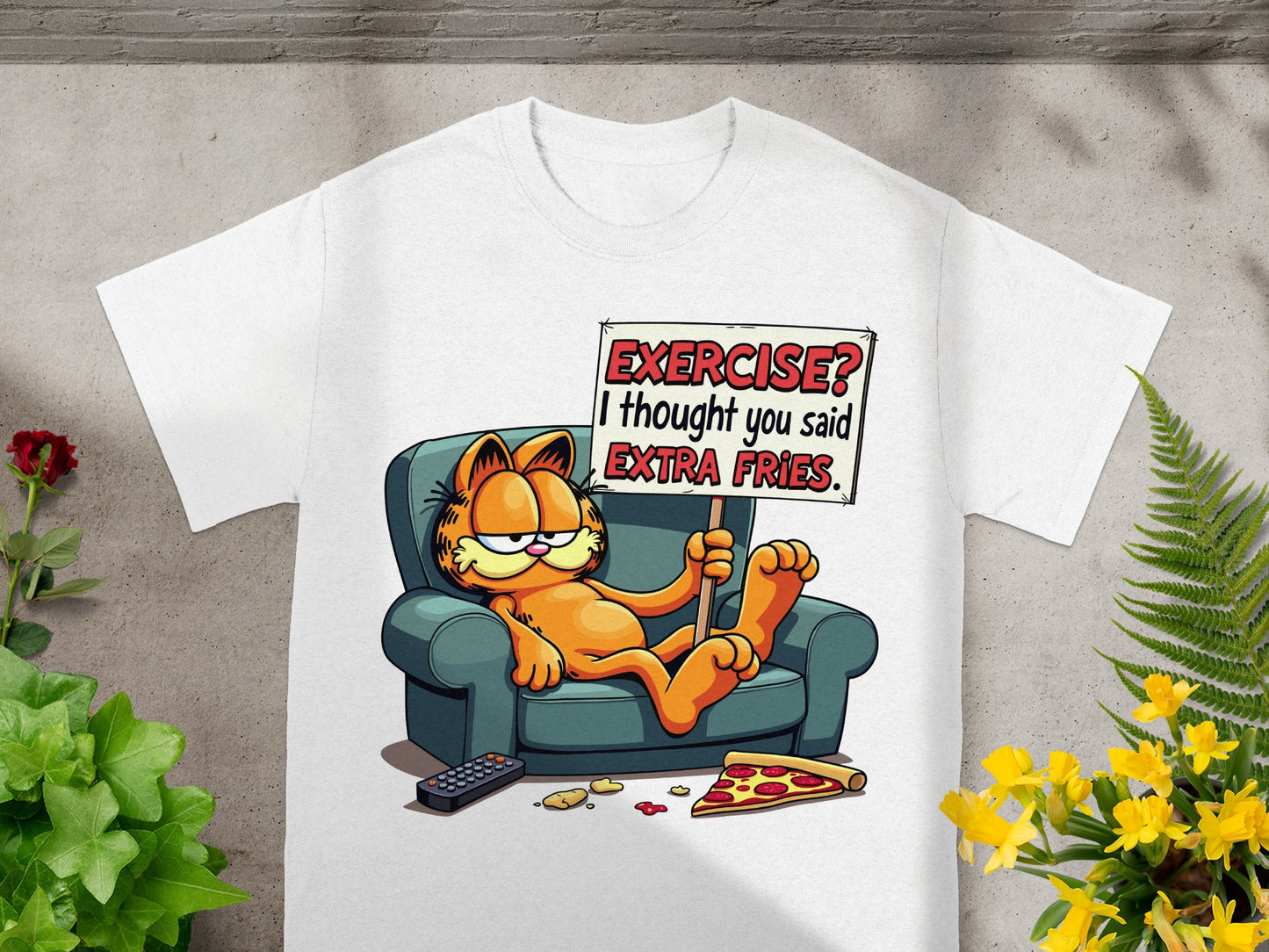 Garfield on a couch holding a sign that says "EXERCISE? I thought you said EXTRA FRIES."