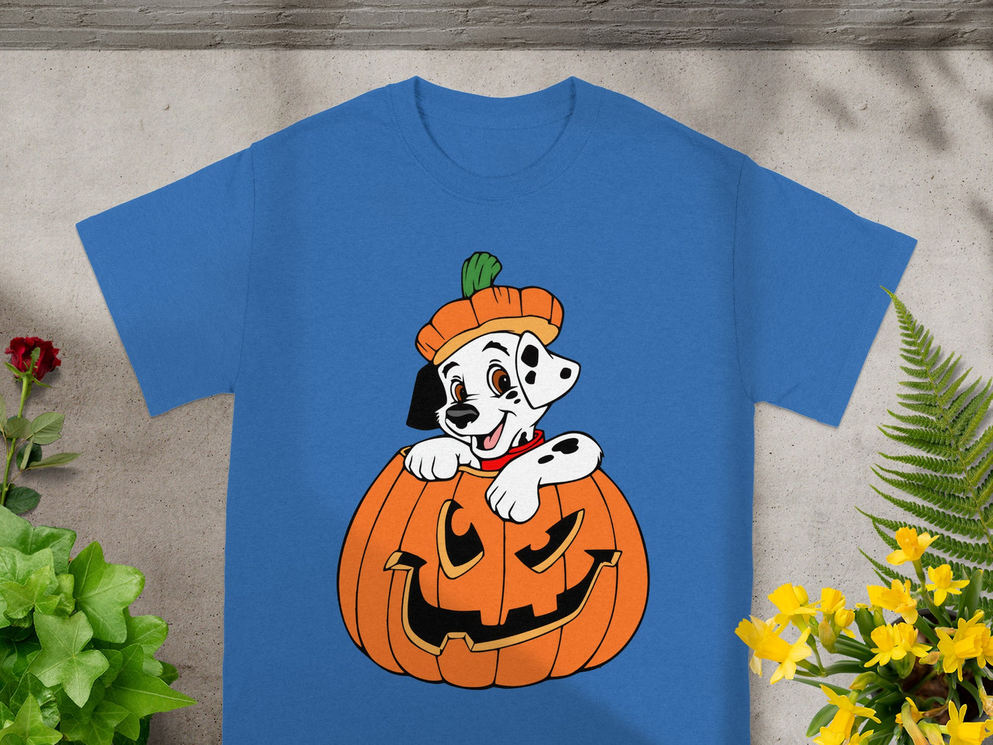 Dalmatian puppy in a pumpkin costume on a blue t-shirt.