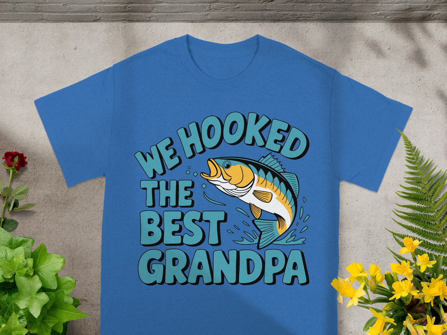 Blue t-shirt with "We Hooked The Best Grandpa" text and a fish design.