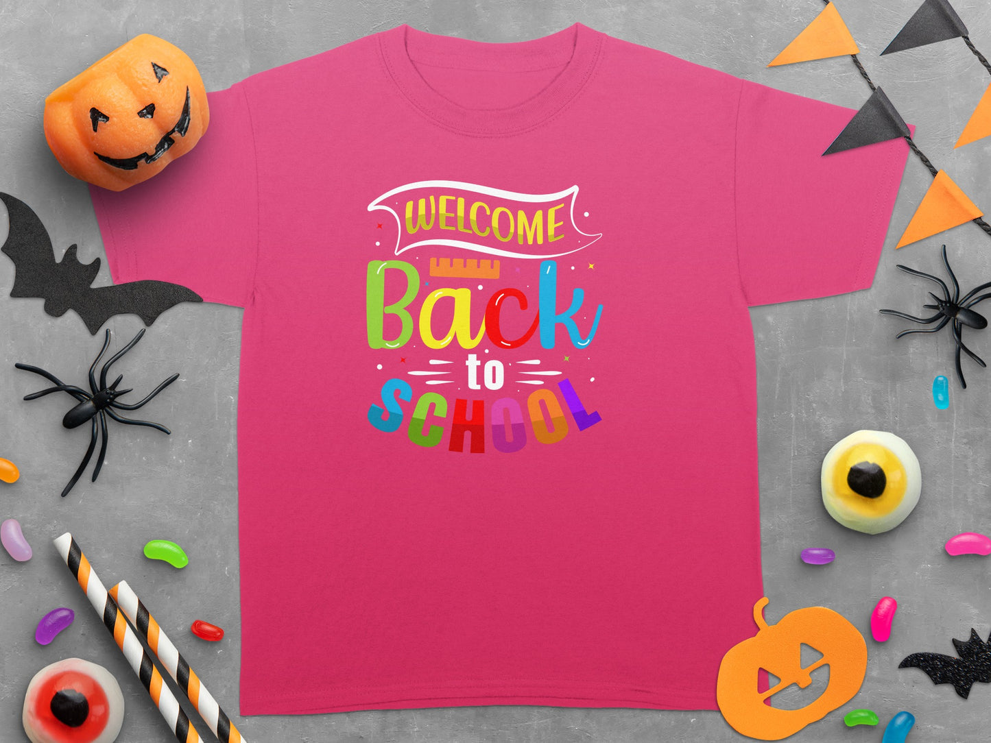 Pink t-shirt with "Welcome Back to School" text and Halloween decorations.