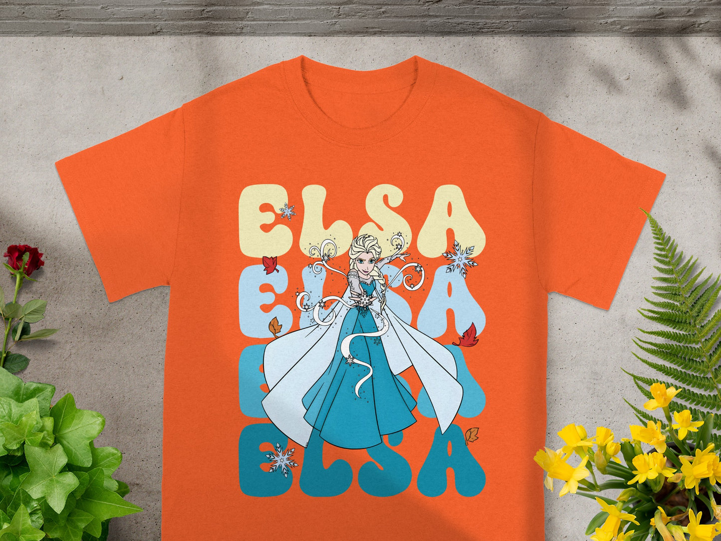 Orange t-shirt with Elsa and colorful "Elsa" text.
