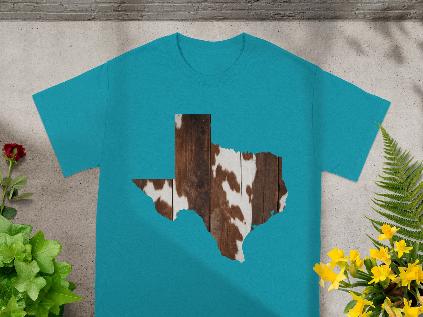 Teal t-shirt with a Texas shape filled with wood and cowhide pattern.