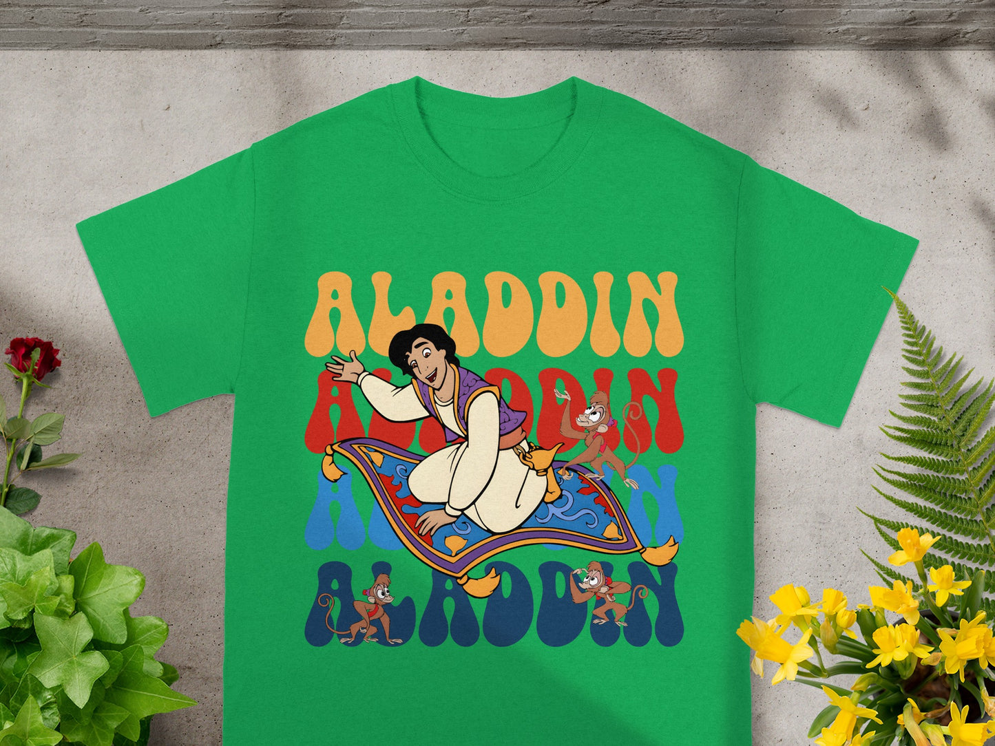 Aladdin rides a magic carpet with Abu and monkeys, surrounded by colorful text.