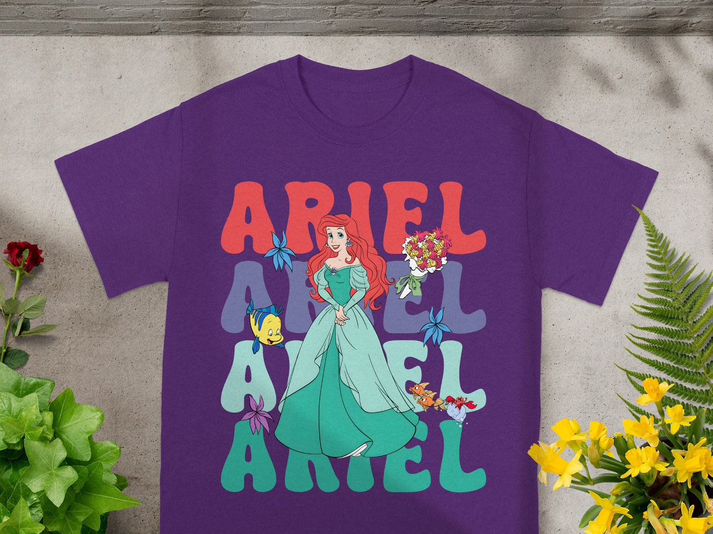 Purple t-shirt with Ariel graphic and "Ariel" text in large letters.