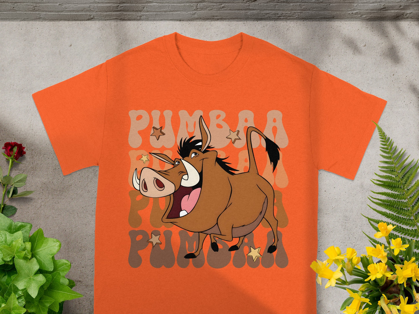 Orange t-shirt with a cartoon meerkat character and "PUMBAA" text.