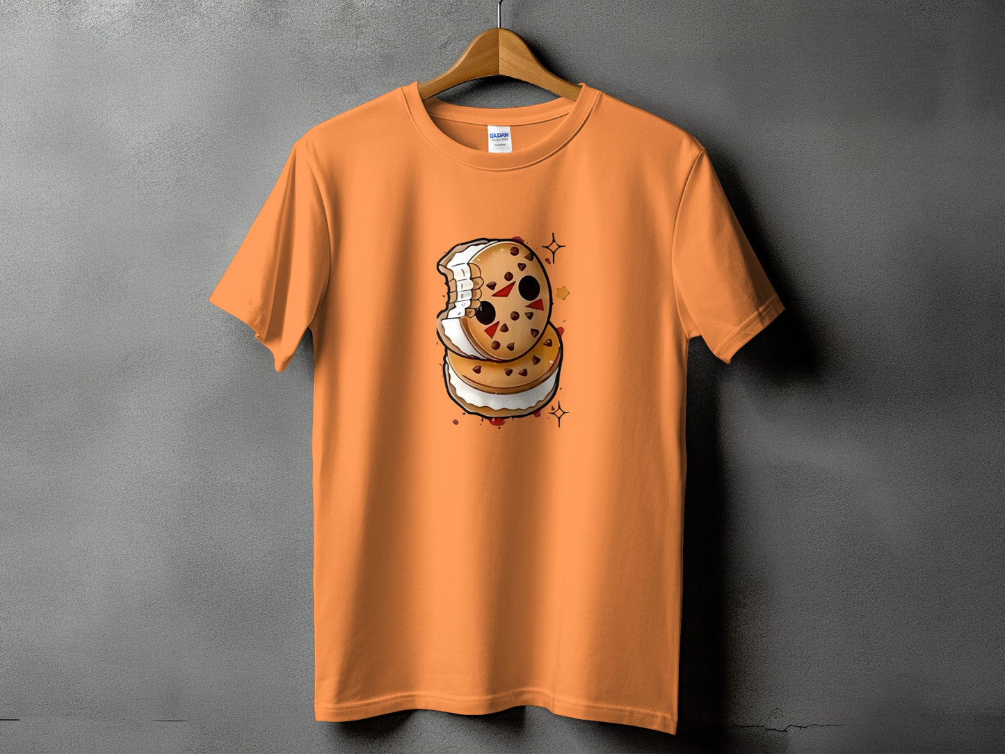Orange t-shirt with a kawaii killer cookie graphic on a hanger.