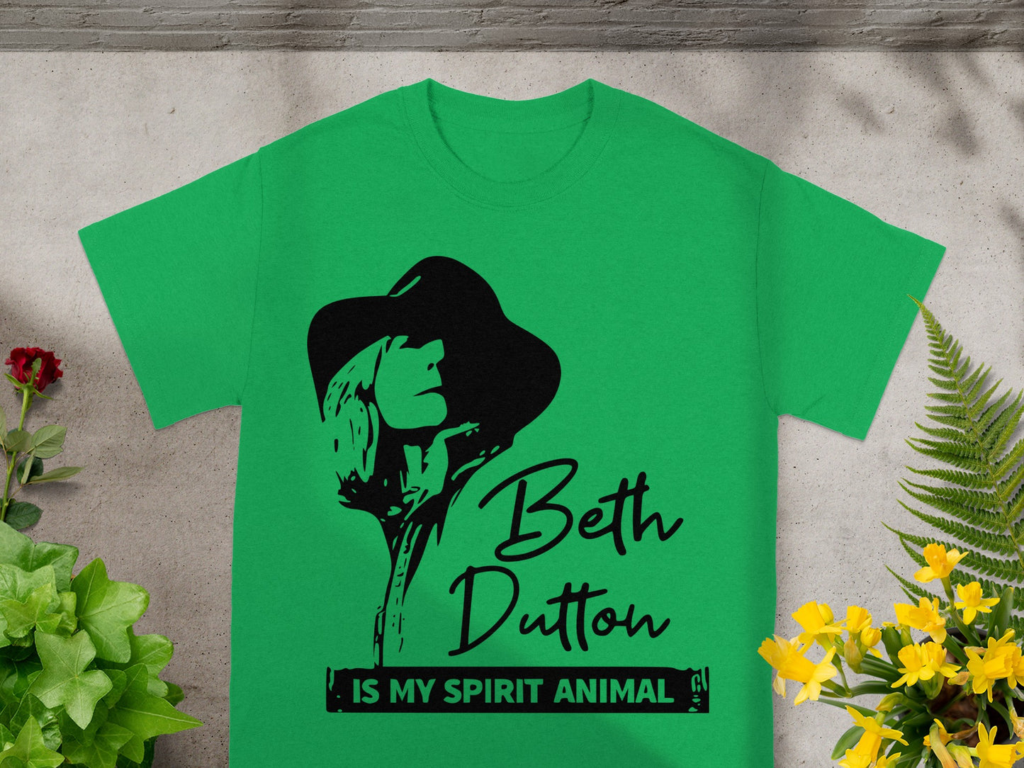 Green t-shirt with black graphic of woman in hat, "Beth Dutton IS MY SPIRIT ANIMAL" text.