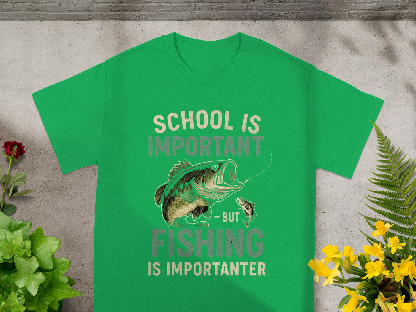 Green t-shirt with text "SCHOOL IS IMPORTANT - BUT FISHING IS IMPORTANTER" and fish graphic.