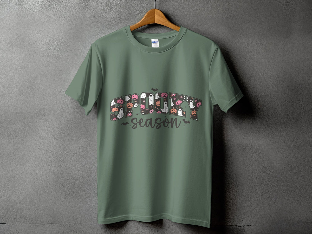 Green t-shirt with "Spooky Season" text featuring pumpkins, ghosts, and flowers.