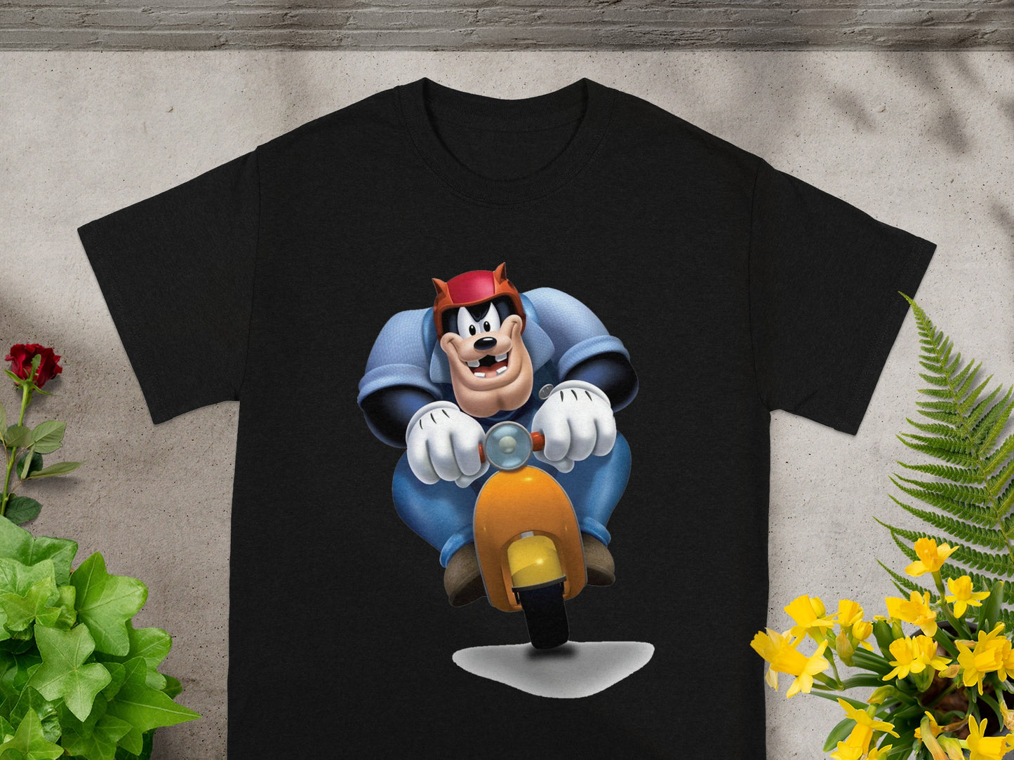 Black t-shirt with cartoon Goofy riding a scooter.