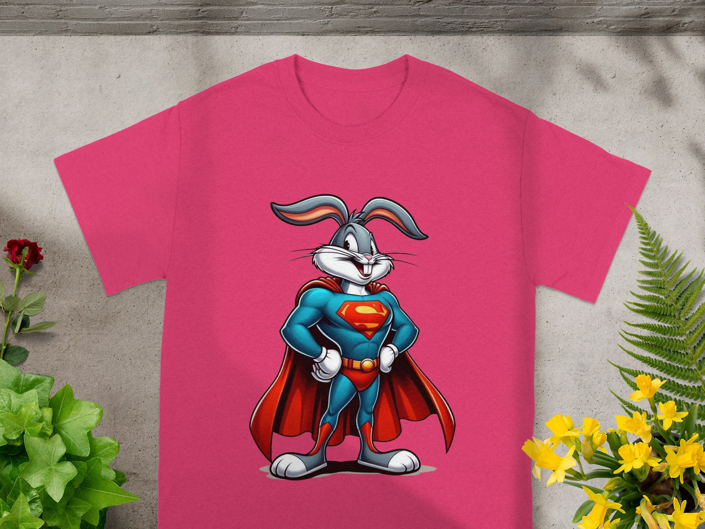 Bugs Bunny as Superman printed on a pink t-shirt with flowers and foliage.