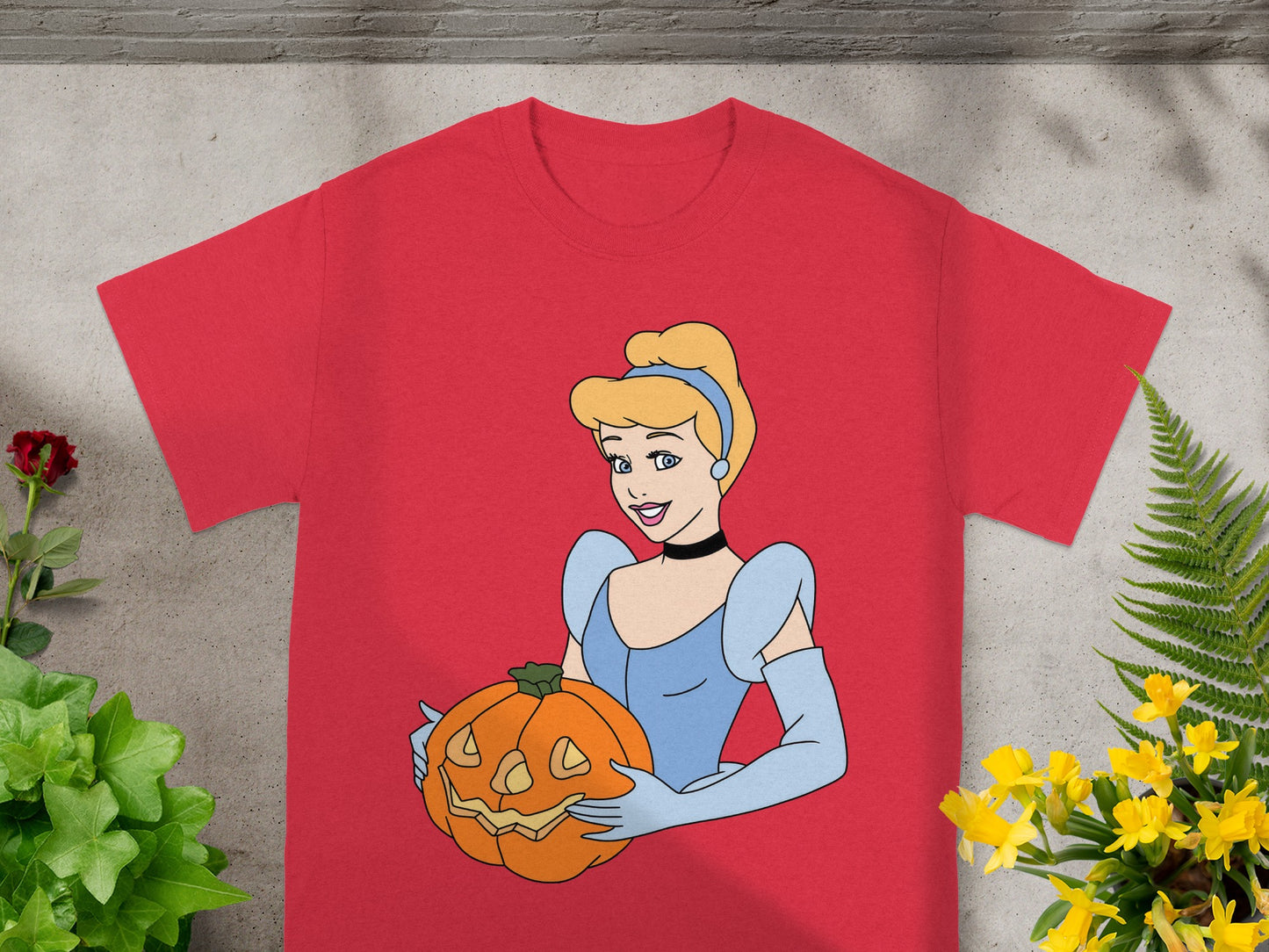 Cinderella holding a jack-o'-lantern on a red t-shirt.