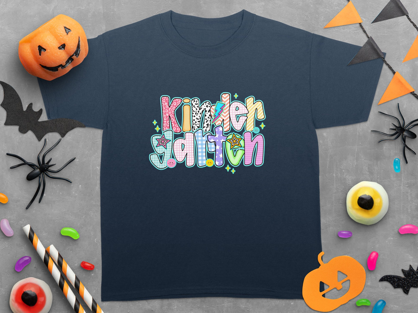 Navy t-shirt with colorful "Kindergarten" text, Halloween decorations, and candy.