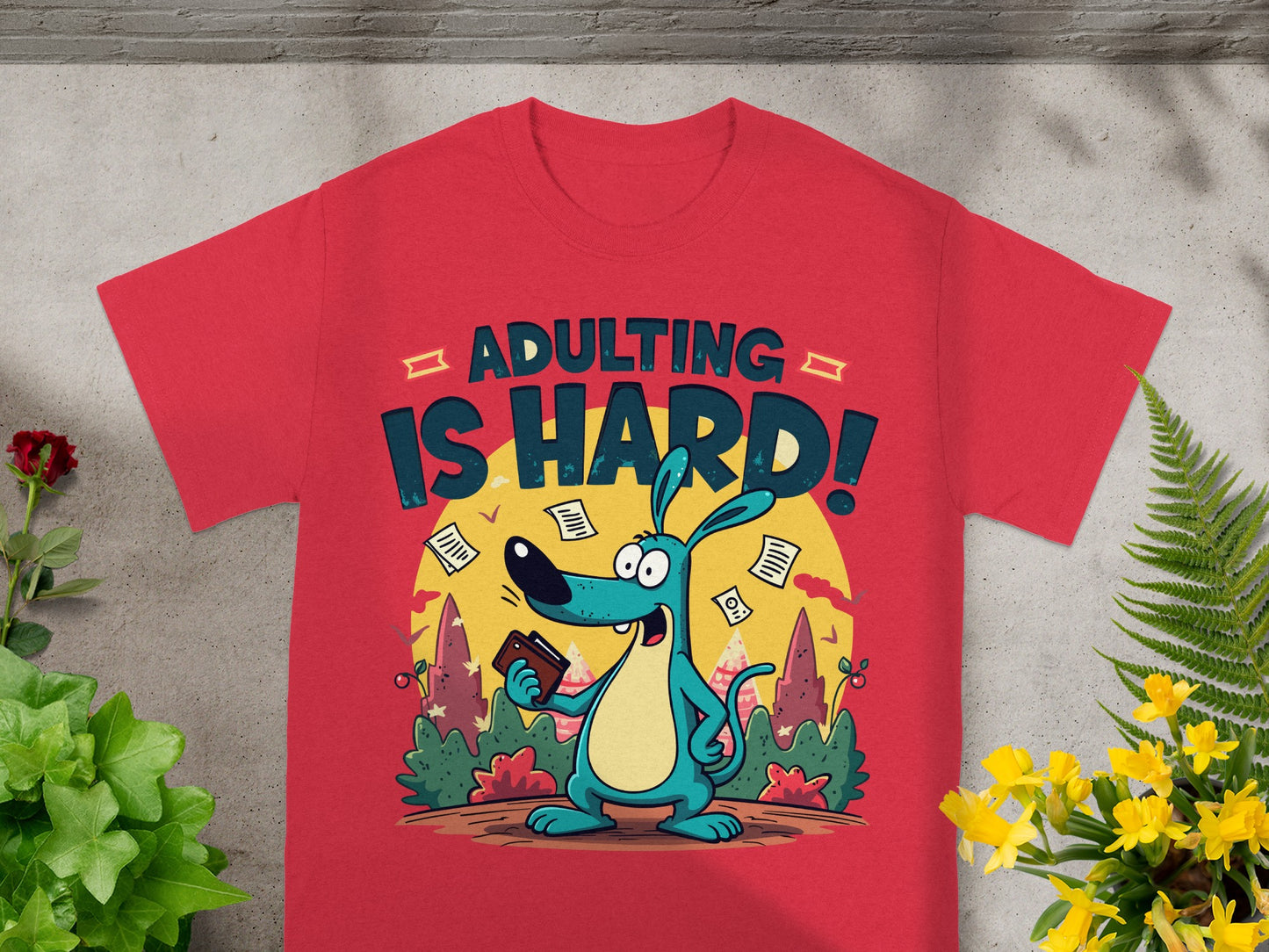 Red t-shirt with cartoon dog and text reading "ADULTING IS HARD!".