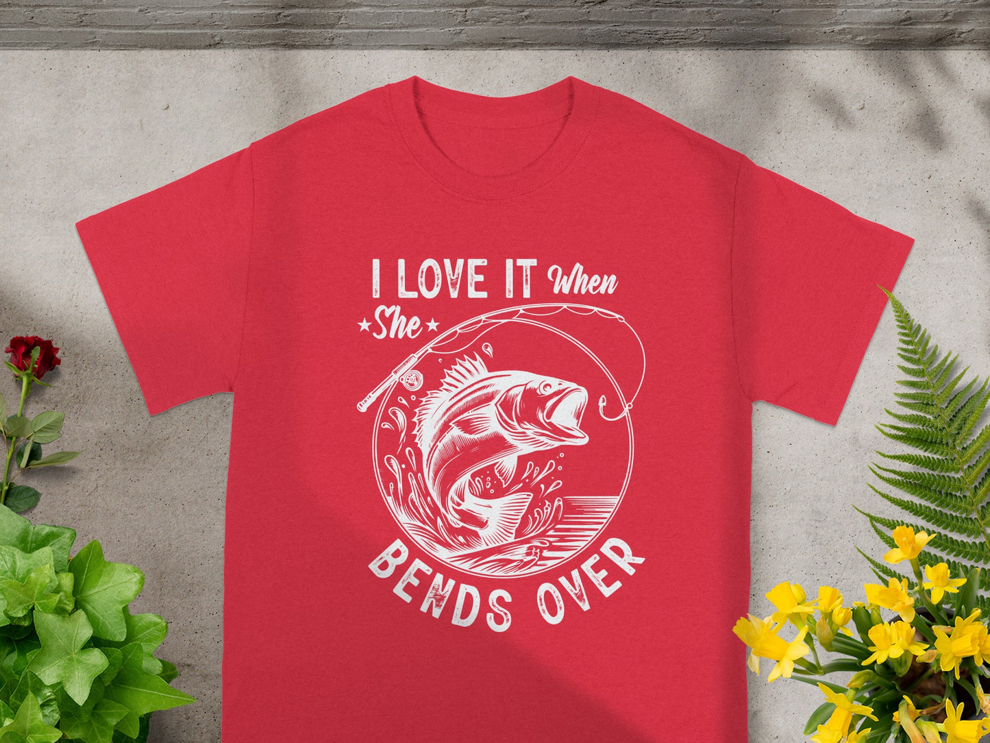Red t-shirt with white graphic of a jumping fish and text "I LOVE IT When She Bends Over".