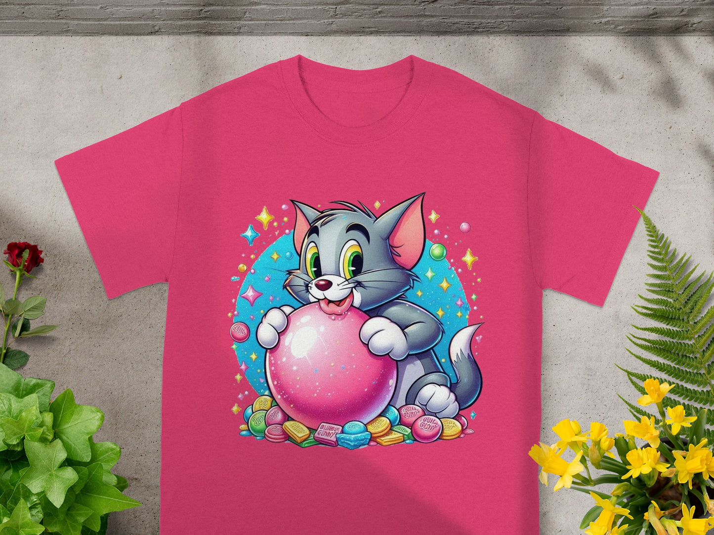 Tom the cat holds a pink ball surrounded by candy and stars.