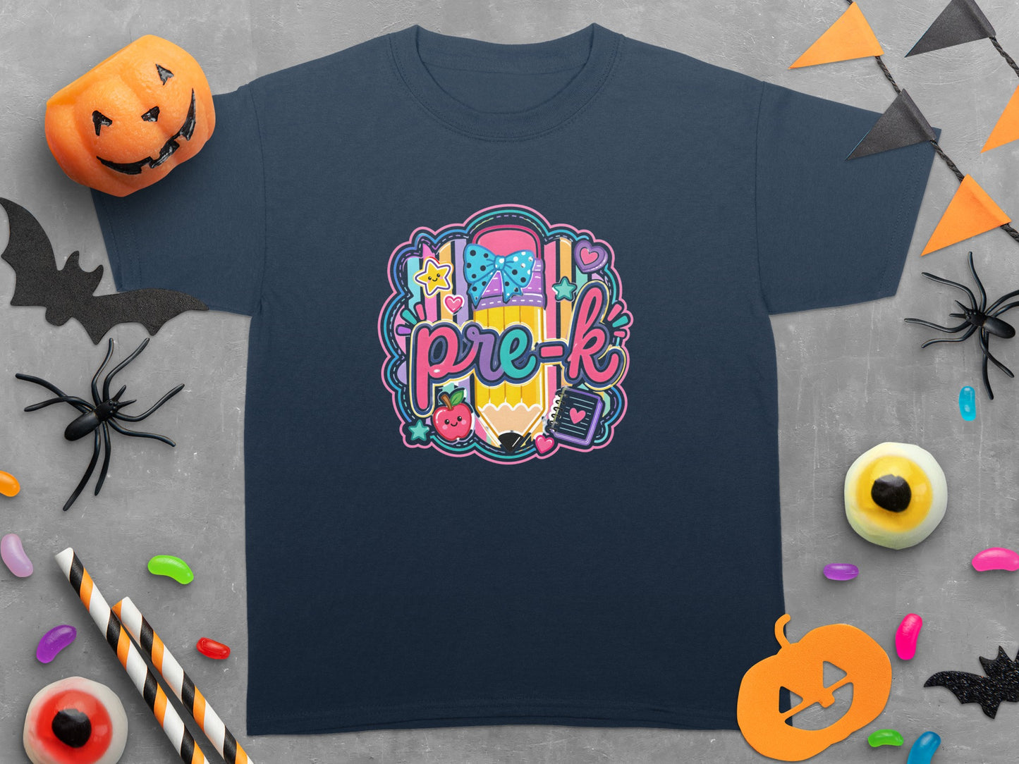 Dark blue t-shirt with a cartoon pencil, apple, and "pre-k" text graphic.