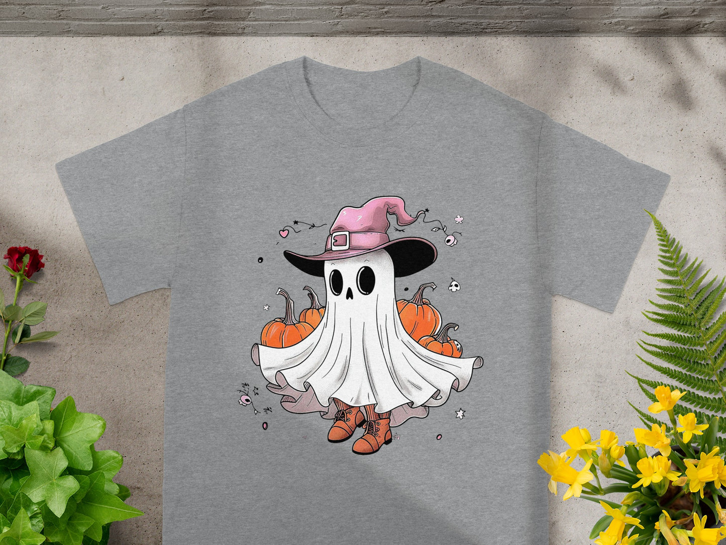 Ghost wearing a witch hat with pumpkins and Halloween decorations on a t-shirt.