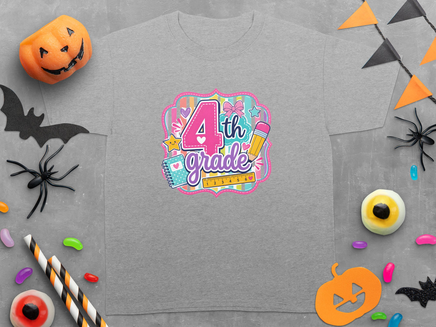 Grey t-shirt with a colorful "4th Grade" graphic featuring school supplies and Halloween decorations.