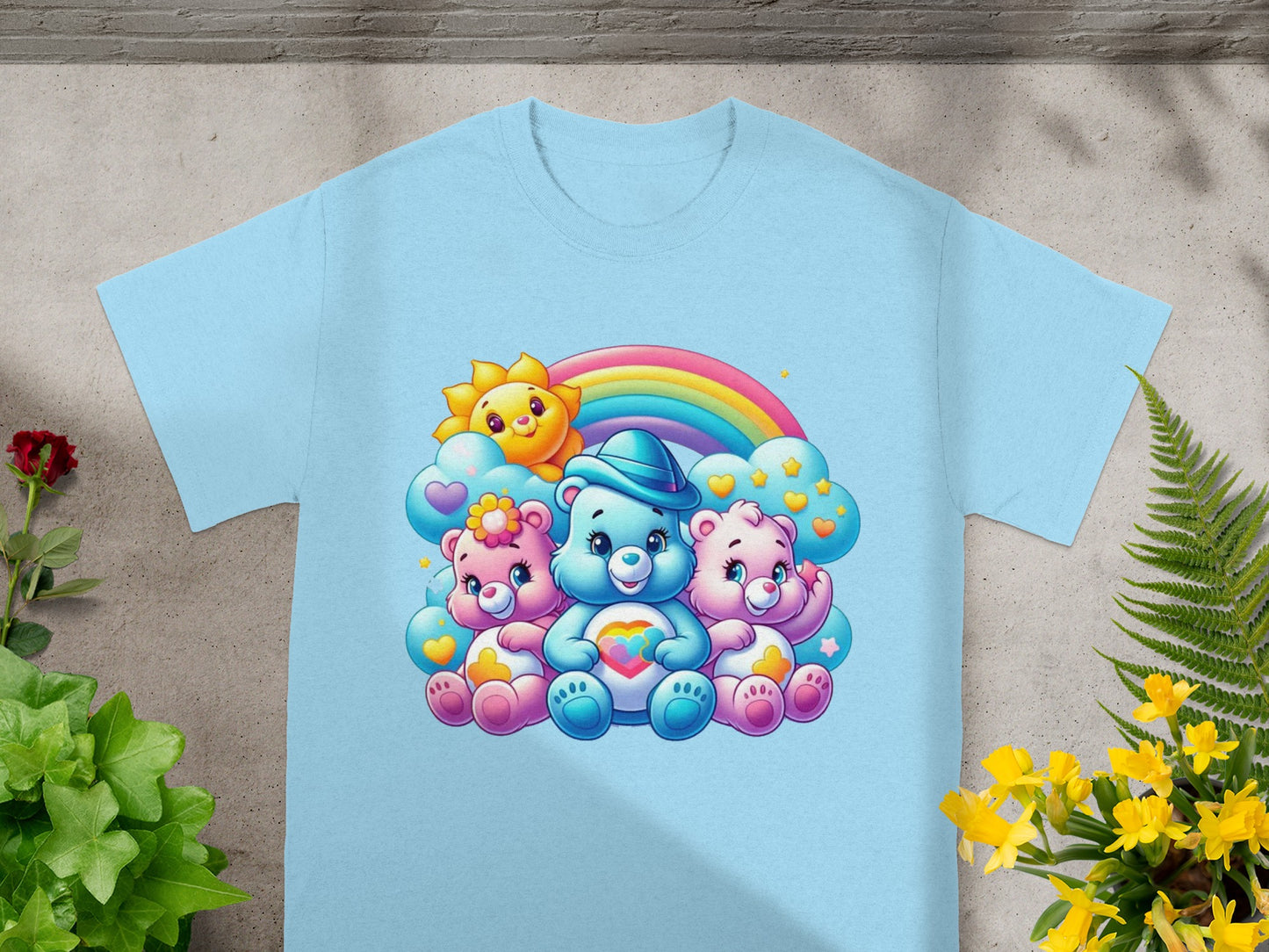 Three Care Bears characters with a rainbow and sun design on a light blue t-shirt.
